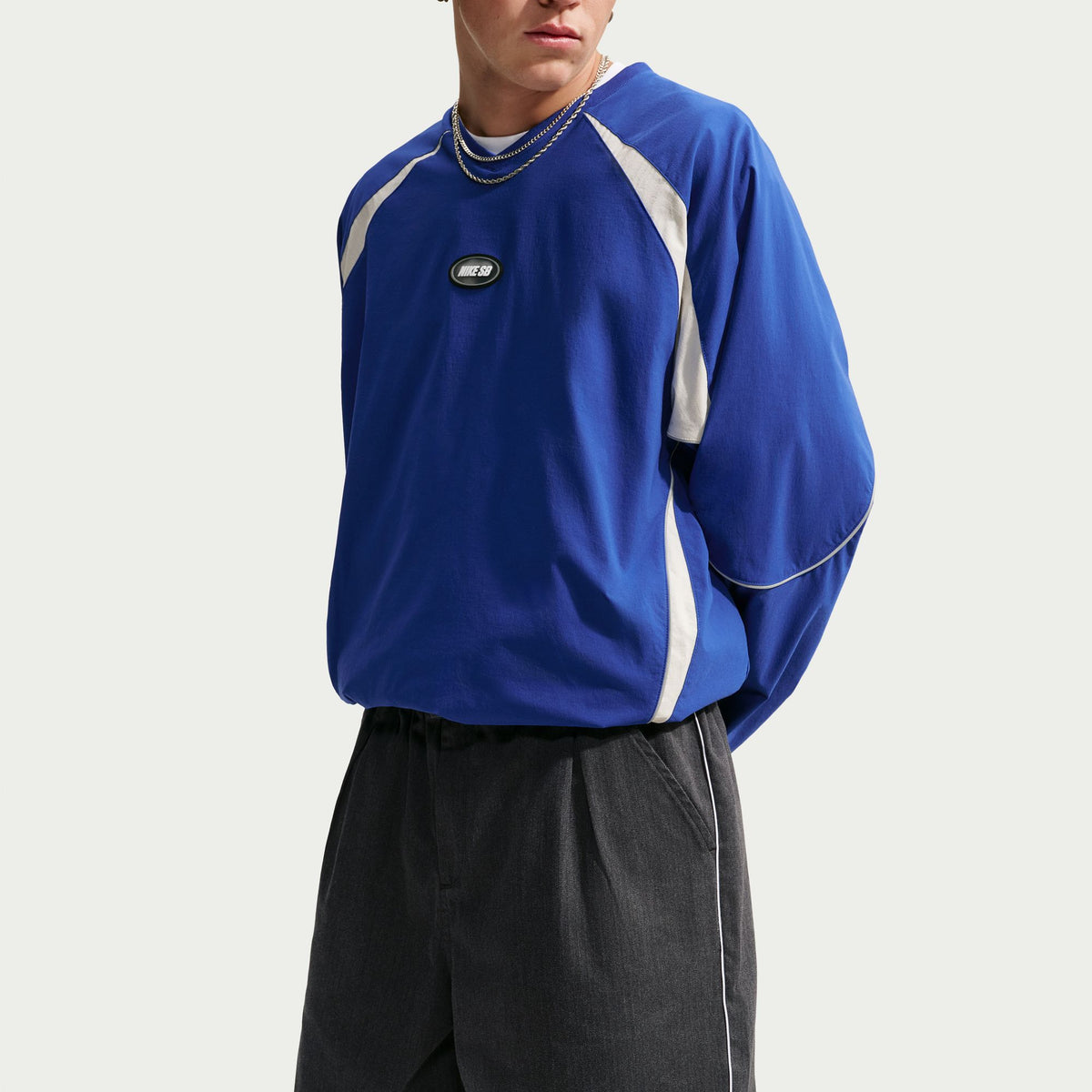 Nike SB Bagel Skate Shorts in Black / White, modelled front close view with a blue long-sleeved top.