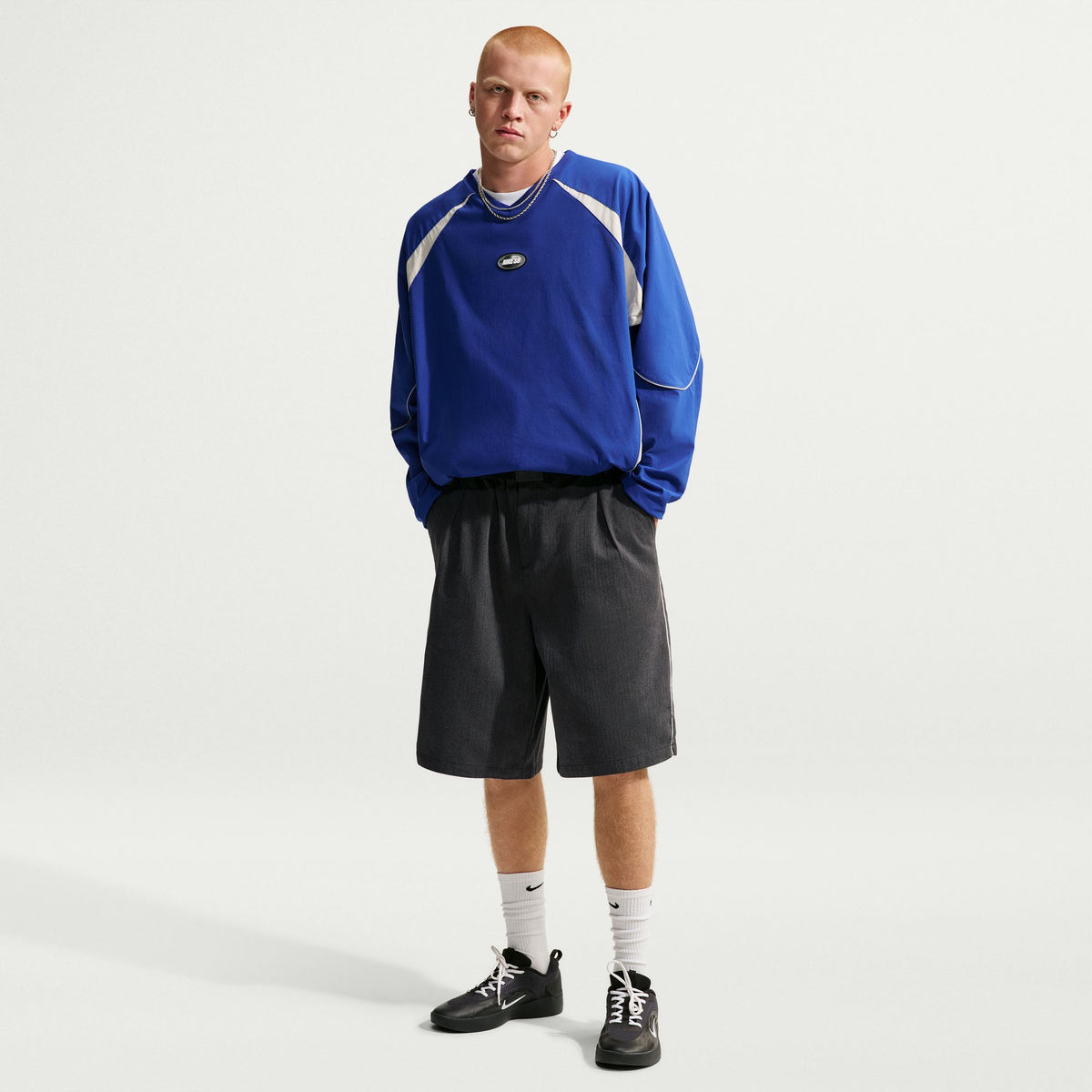 Nike SB Bagel Skate Shorts in Black / White, modelled front outfit view showing the wide, knee-length cut.
