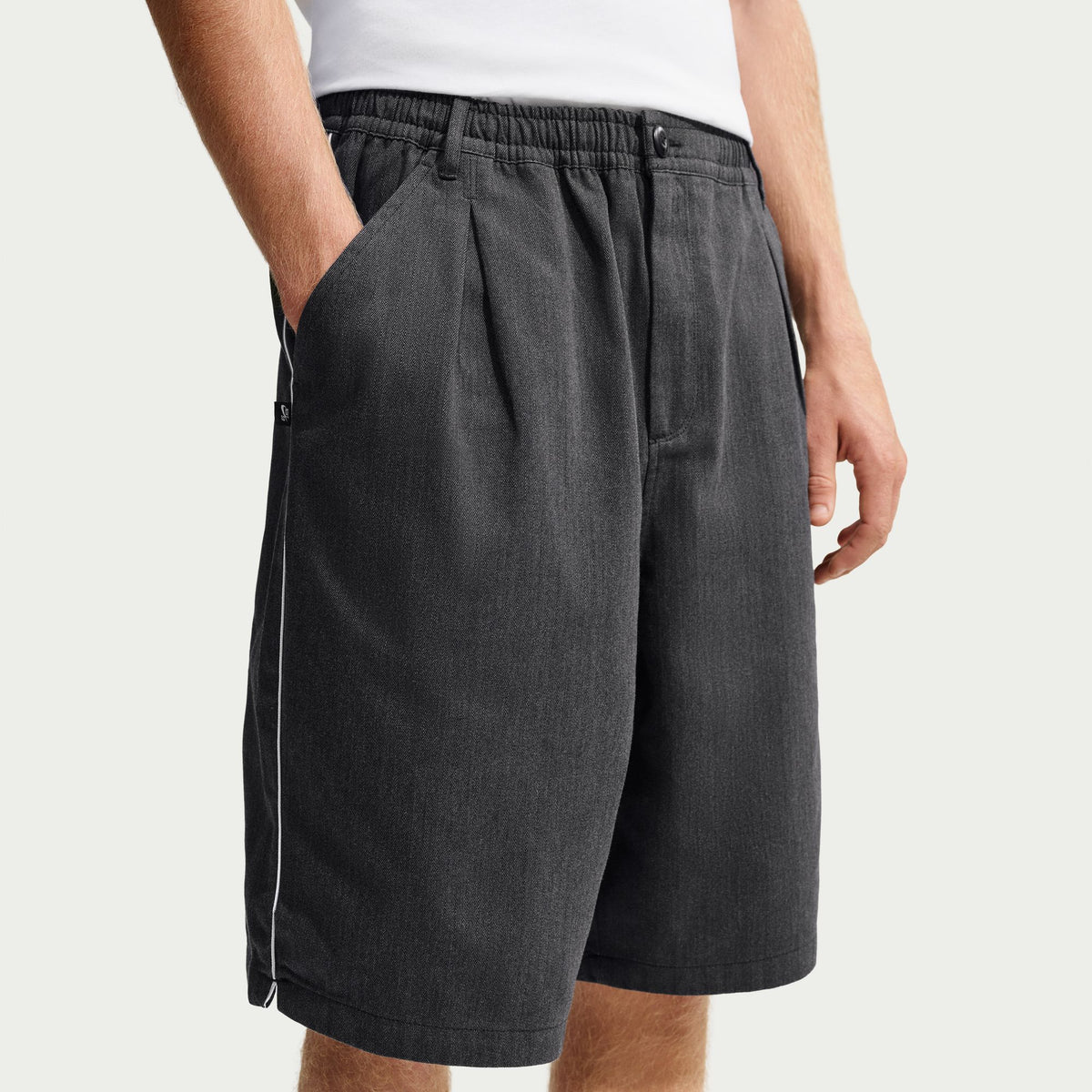 Nike SB Bagel Skate Shorts in Black / White, modelled close-up of the front pockets and waistband.