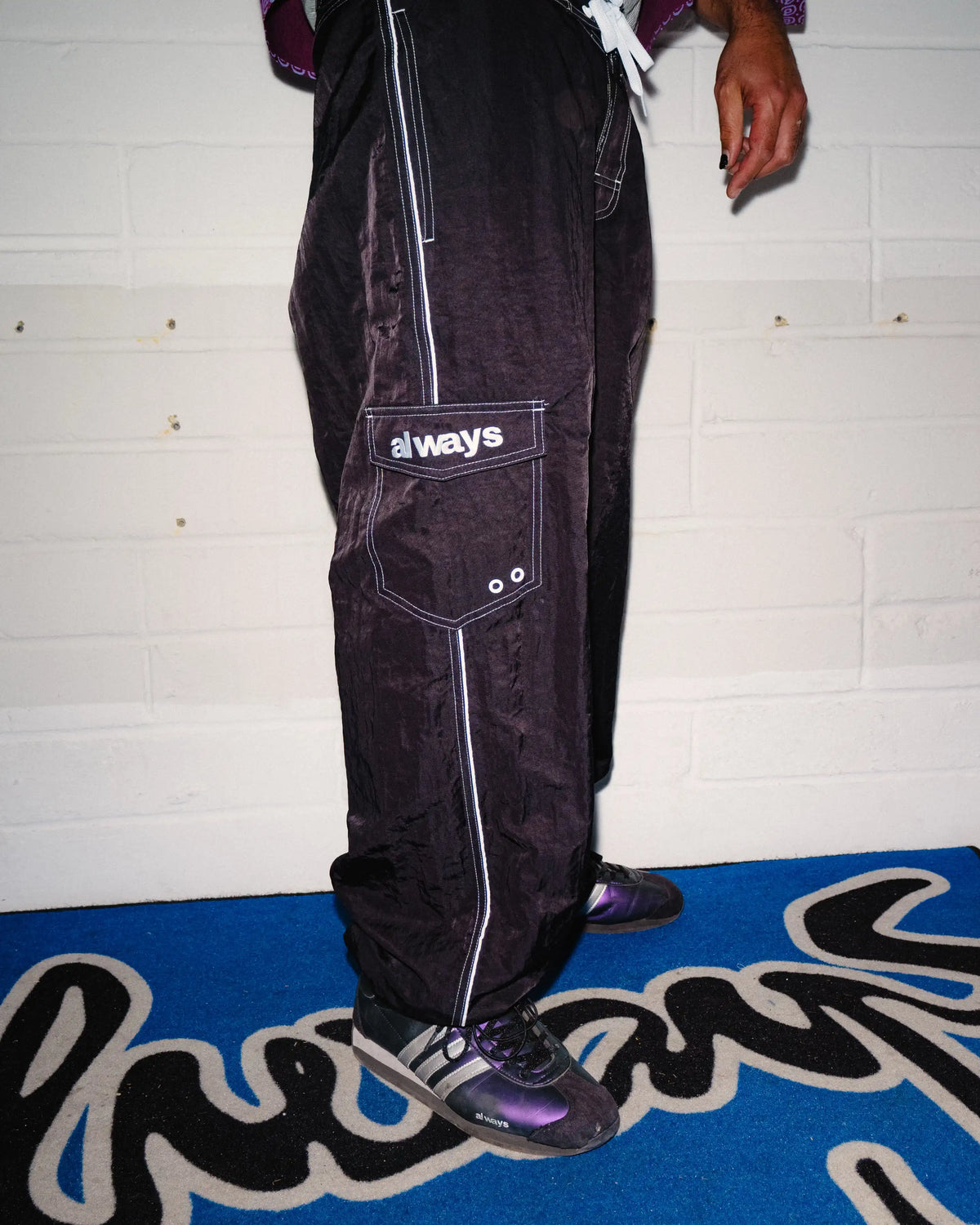 Always Do What You Should Do Piping Long Boardies in Black, side view worn by a model, showing the cargo pocket and contrast seams
