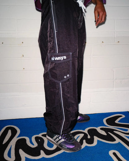 Always Do What You Should Do Piping Long Boardies in Black, side view worn by a model, showing the cargo pocket and contrast seams